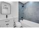Updated bathroom with gray tile and modern vanity at 2028 Hassell Ave, North Las Vegas, NV 89032