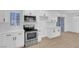 Modern white kitchen with stainless steel appliances at 2028 Hassell Ave, North Las Vegas, NV 89032