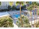 Community pool with surrounding palm trees at 205 E Harmon Ave # 707, Las Vegas, NV 89169