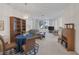 Living room features a gray couch, wood shelving, and a dining table for six at 2116 Point Mallard Dr, Henderson, NV 89012