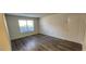Simple bedroom with hardwood floors and large window at 2300 E Silverado Ranch Blvd # 1151, Las Vegas, NV 89183