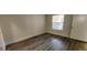 Bedroom featuring wood-look flooring and large window at 2300 E Silverado Ranch Blvd # 1151, Las Vegas, NV 89183