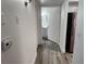 Hallway with light walls and wood-look laminate flooring at 2300 E Silverado Ranch Blvd # 1151, Las Vegas, NV 89183