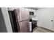 Modern kitchen featuring stainless steel appliances and light wood laminate flooring at 2300 E Silverado Ranch Blvd # 1151, Las Vegas, NV 89183