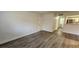 Open living room with hardwood floors and access to kitchen and hallway at 2300 E Silverado Ranch Blvd # 1151, Las Vegas, NV 89183
