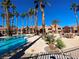 Inviting community pool area with palm trees and lounge chairs for relaxing at 2300 E Silverado Ranch Blvd # 1151, Las Vegas, NV 89183