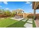 Covered patio with seating area and lush landscaping at 286 Chartan Ave, Las Vegas, NV 89183