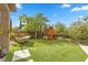 Playful backyard with playground, hammock, and lush lawn at 286 Chartan Ave, Las Vegas, NV 89183
