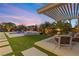Outdoor patio with pergola, pool, and spa at sunset at 286 Chartan Ave, Las Vegas, NV 89183