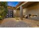 Elegant courtyard entry with fireplace and string lights at 286 Chartan Ave, Las Vegas, NV 89183