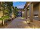 Inviting courtyard entry with fireplace and string lights at 286 Chartan Ave, Las Vegas, NV 89183