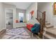 Stunning hallway with a built-in window seat, colorful rug, and teal accent chair at 286 Chartan Ave, Las Vegas, NV 89183