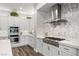 Modern kitchen with white cabinets, stainless steel appliances, and hexagon backsplash at 286 Chartan Ave, Las Vegas, NV 89183
