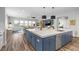 Large kitchen island with seating, blue cabinets, and stainless steel dishwasher at 286 Chartan Ave, Las Vegas, NV 89183