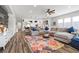 Open concept living room and kitchen with large sectional sofa and area rug at 286 Chartan Ave, Las Vegas, NV 89183