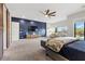 Spacious main bedroom with a large TV, barn doors and a cozy sitting area at 286 Chartan Ave, Las Vegas, NV 89183
