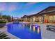 Expansive pool and spa with lighting, and relaxing lounge chairs at 286 Chartan Ave, Las Vegas, NV 89183