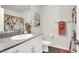 Clean bathroom with granite countertop and floral accents at 2905 Bahama Yellow Ave, North Las Vegas, NV 89086