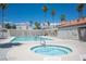 Community pool and spa with lounge chairs at 3150 Soft Breezes Dr # 2214, Las Vegas, NV 89128