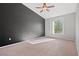Spacious bedroom with carpet flooring, ceiling fan and large window at 3540 Cactus Shadow St # 201, Las Vegas, NV 89129