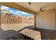 Backyard with a covered patio and a rock wall at 395 Nine Mile Creek Dr, Las Vegas, NV 89138