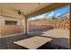 Backyard features a covered patio area and a rock wall for privacy at 395 Nine Mile Creek Dr, Las Vegas, NV 89138