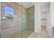 Modern bathroom featuring tiled walls, glass shower, and a window for natural light at 395 Nine Mile Creek Dr, Las Vegas, NV 89138
