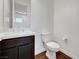 Well-lit half-bath with a modern vanity, toilet, and hardwood floors at 395 Nine Mile Creek Dr, Las Vegas, NV 89138