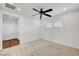 Spacious bedroom with carpet, a ceiling fan, and wood flooring in the hallway at 395 Nine Mile Creek Dr, Las Vegas, NV 89138