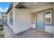 Inviting home entrance with a blue front door, stone walkway, and decorative exterior lighting at 395 Nine Mile Creek Dr, Las Vegas, NV 89138