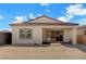 Back exterior of a single story house with a tile roof and stone wall at 395 Nine Mile Creek Dr, Las Vegas, NV 89138