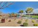 Community playground with play equipment and shaded picnic area on a sunny day at 395 Nine Mile Creek Dr, Las Vegas, NV 89138