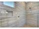 Detailed view of the walk-in shower featuring tiled walls and a built-in niche for storage at 395 Nine Mile Creek Dr, Las Vegas, NV 89138