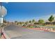 Neighborhood street view showcasing landscaping and community entrance at 395 Nine Mile Creek Dr, Las Vegas, NV 89138