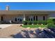 Landscaped backyard with grassy area, bushes, and patio at 4638 Evan Ridge Ct, Las Vegas, NV 89129