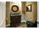 Elegant powder room with a dark vanity and granite countertop at 4638 Evan Ridge Ct, Las Vegas, NV 89129