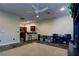 Open living space with kitchen bar, tiled floors and ceiling fan at 4638 Evan Ridge Ct, Las Vegas, NV 89129