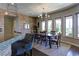 Bright dining room with large windows and a rustic wooden table at 4638 Evan Ridge Ct, Las Vegas, NV 89129