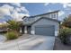 Two-story house with gray siding, landscaping, and a driveway at 4929 Shady Rim Ct, Las Vegas, NV 89131