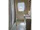 Bright bathroom featuring a vanity with a sink and a window with a lace curtain at 509 5Th St, Boulder City, NV 89005