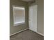 Bedroom with a window, carpet flooring, and a white door at 509 5Th St, Boulder City, NV 89005