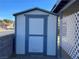 White and blue storage shed with lattice fence at 509 5Th St, Boulder City, NV 89005