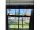 View through a window overlooking a green front lawn and neighborhood street at 509 5Th St, Boulder City, NV 89005