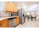 Modern kitchen with stainless steel appliances and wood cabinets at 5305 Manor Stone St, North Las Vegas, NV 89081