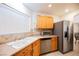 Modern kitchen with stainless steel appliances and wood cabinets at 5305 Manor Stone St, North Las Vegas, NV 89081