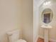 Small bathroom with pedestal sink and rounded mirror at 5648 Ancient Agora St, North Las Vegas, NV 89031
