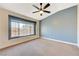 Spacious bedroom with ceiling fan and large window at 5648 Ancient Agora St, North Las Vegas, NV 89031