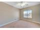 Bright bedroom with ceiling fan and large window at 5648 Ancient Agora St, North Las Vegas, NV 89031