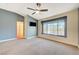 Main bedroom with large window, ceiling fan, and access to bathroom at 5648 Ancient Agora St, North Las Vegas, NV 89031