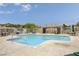 Relaxing community pool with lounge chairs and picnic tables at 5648 Ancient Agora St, North Las Vegas, NV 89031